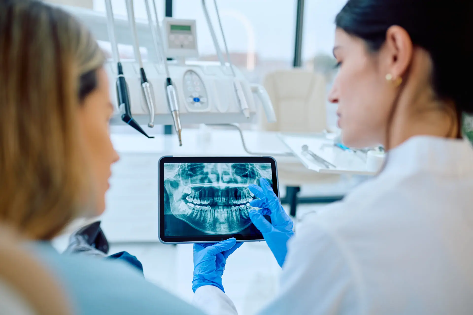Dentist reviewing digital dental X-rays with a patient to explain oral health findings during an Ottawa dental appointment