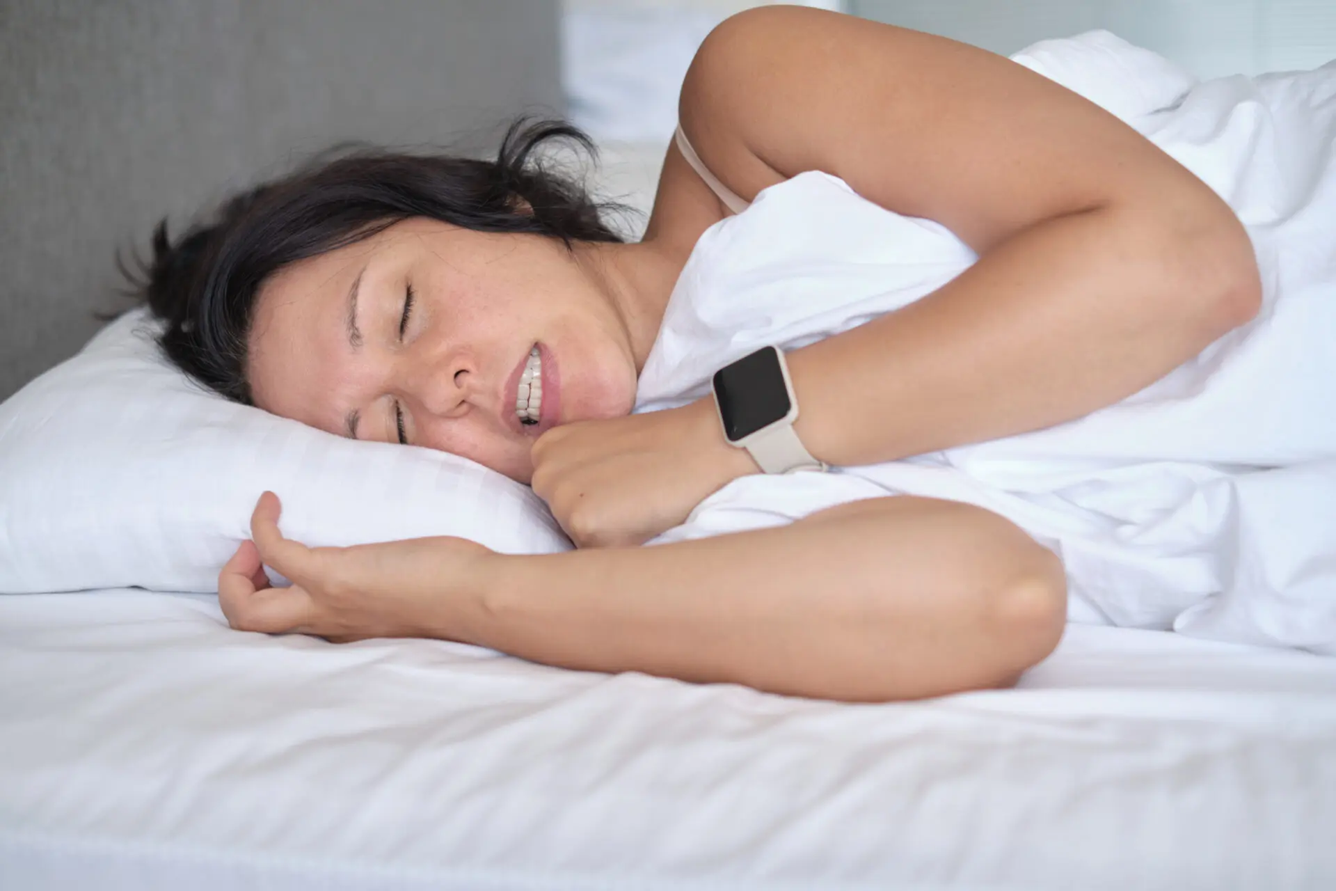 Clenched jaw in sleep, a sign of stress; the intimate side-view shot. Highlights bruxism concerns in today's high-stress lifestyles.