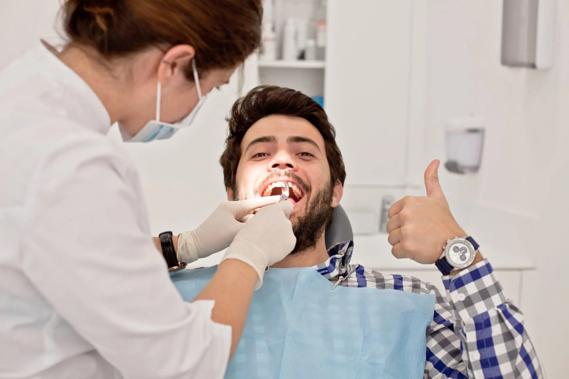 young happy man in a dental examination at dentist