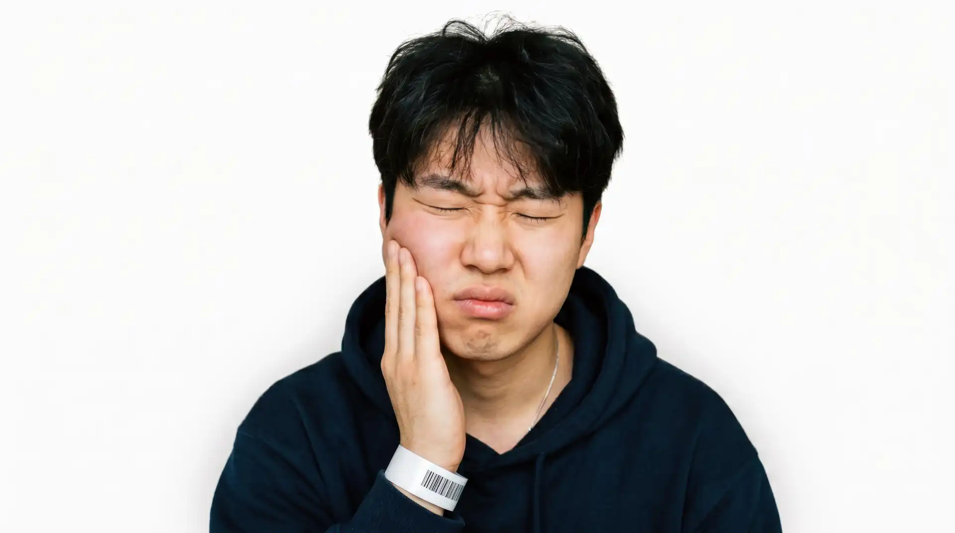 Man holding his cheek while experiencing dental discomfort